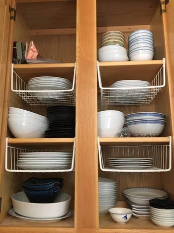 a reviewer photo of a dish cabinet with the under-shelf baskets installed 