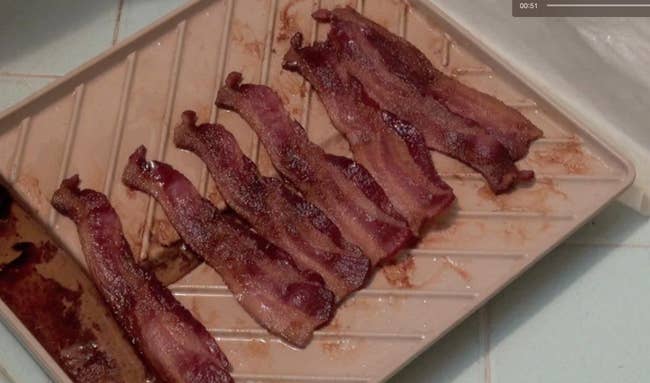 The microwavable bacon tray with seven pieces of crispy ready-to-eat bacon on top
