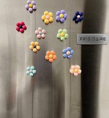 Reviewer image of flower magnets with puffy petals on a fridge 