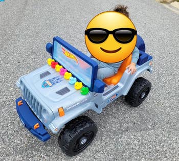 Child in a battery operated hot wheels jeep