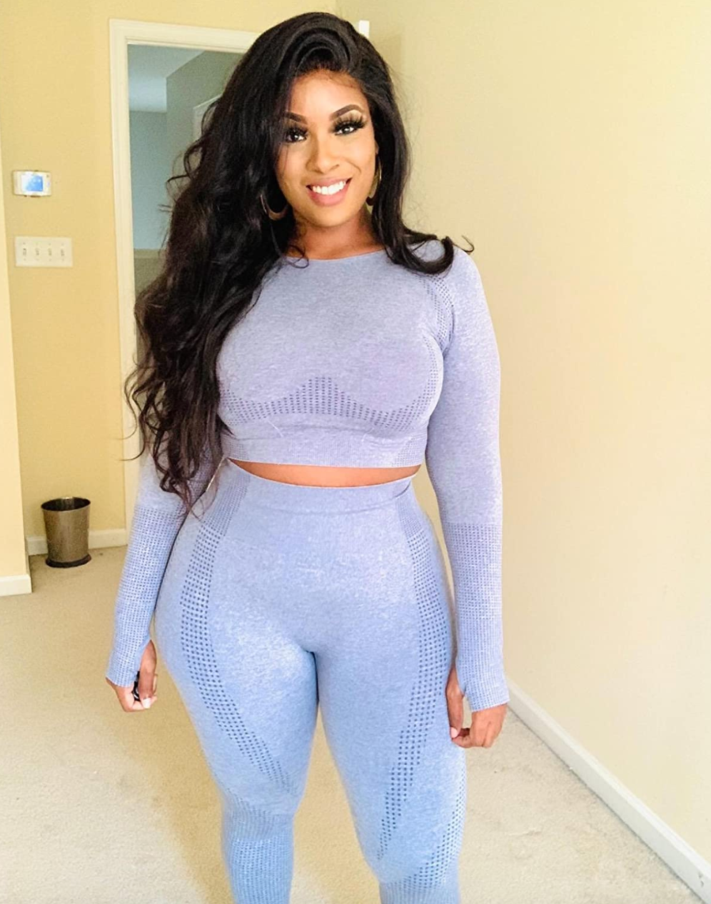 reviewer wearing purple set