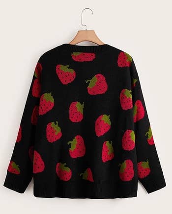 the back view of the cardigan in black with a red strawberry print 