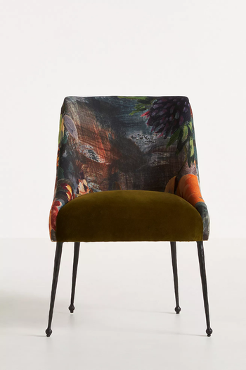 Floral patterned armless chair with olive green seat and black metal legs