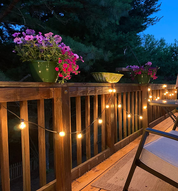 globe lights strung along a porch fence