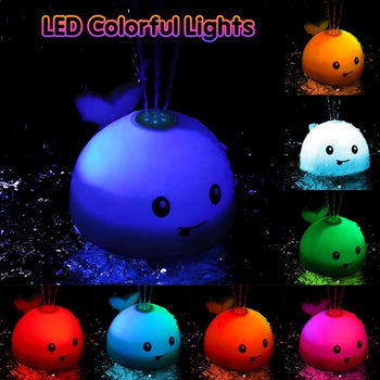 an led whale in various colors shooting water out of the top