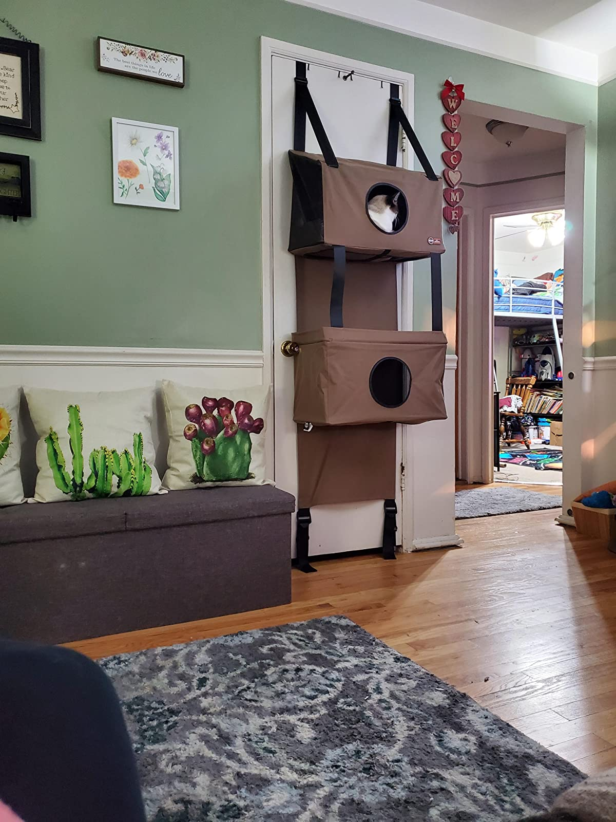 The four-level cat condo, which has entrances/ peepholes on several floors, and attaches to the back of doors with built-in straps