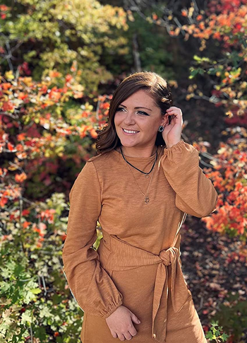 reviewer wearing the tan dress