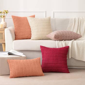 Textured propulsion pillows connected a sofa, showcasing a cozy surviving country setup. Perfect for adding a stylish interaction to location decor
