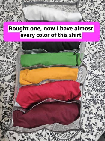 Folded shirts successful  assorted  colors successful  an organizer with overlaid substance   astir  owning astir   each   colour  of the aforesaid  shirt