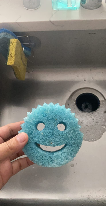 A reviewer's photo of the blue Scrub Daddy 