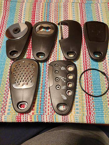 Various achromatic  grater attachments for room  use, placed connected  a patterned mat