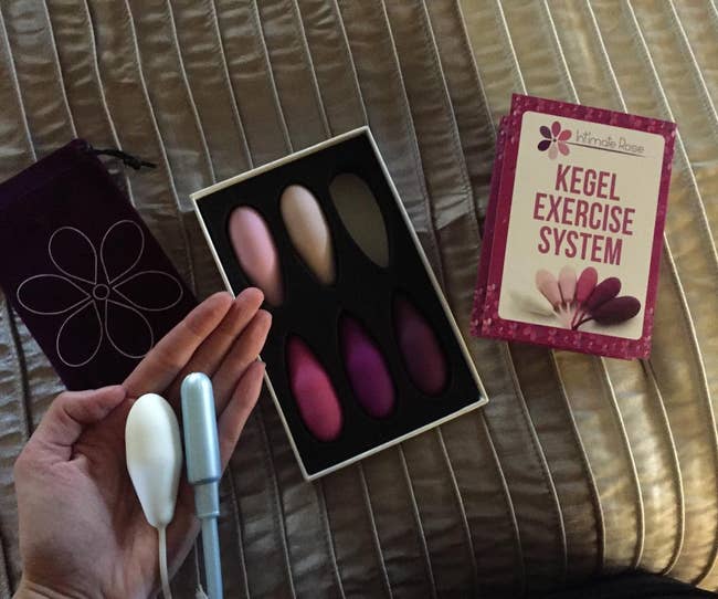 reviewer holding one of the weights next to a tampon to show they're similar in size