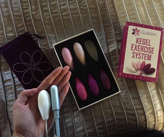reviewer holding one of the weights next to a tampon to show they're similar in size