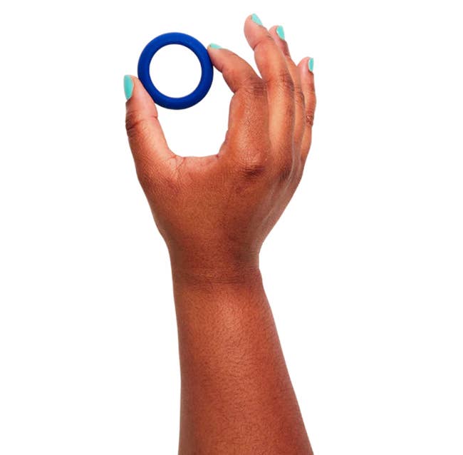Model holding blue cock ring
