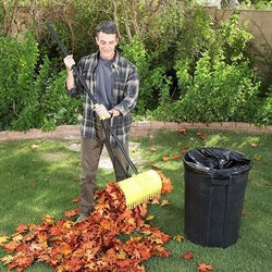 model using the same rake to grab a pile of leaves like a claw hand