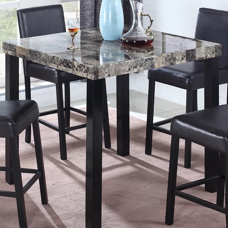 A mable top table with chairs