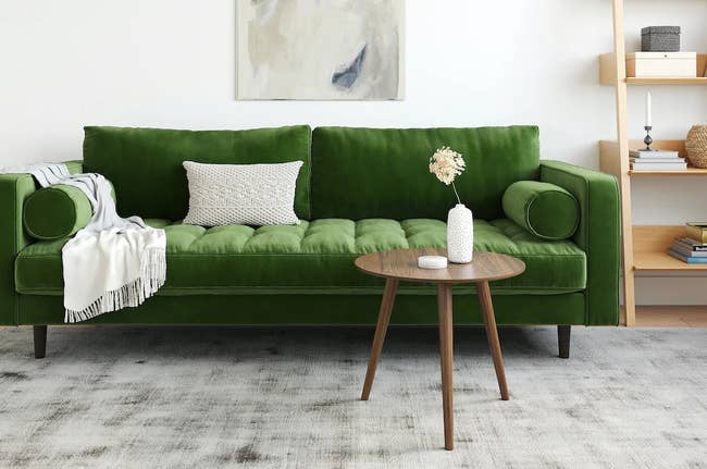 the green velvet couch in a living room