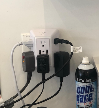 Reviewer photo of the outlet with multiple electronics plugged into it