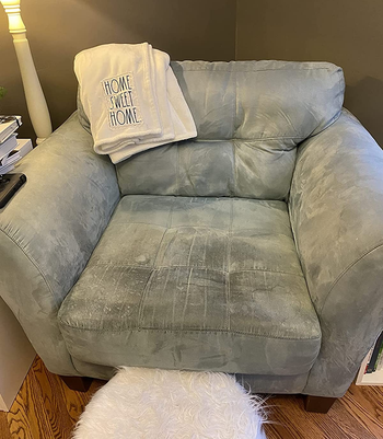 reviewer before image of a stained and dirty grey armchair