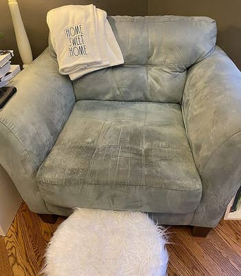 reviewer before image of a stained and dirty grey armchair
