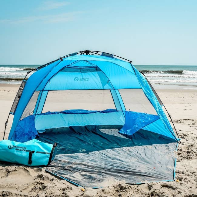 blue pop-up tent on the beach