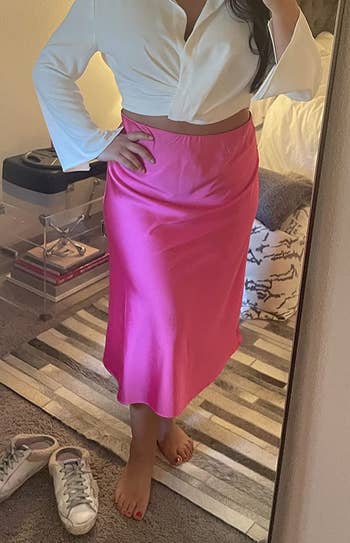 reviewer wearing the pink skirt with a white top