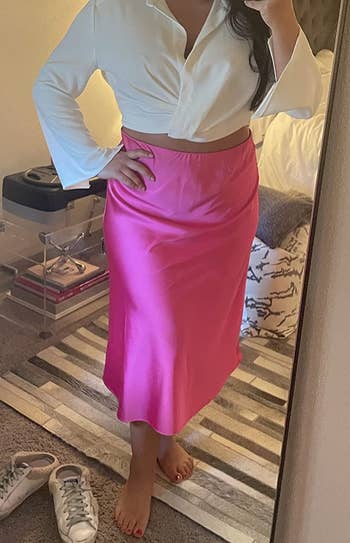 reviewer wearing the pink skirt with a white top