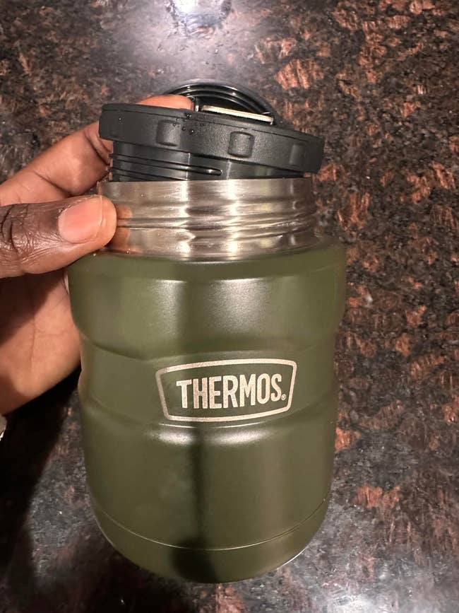 hand holding thermos