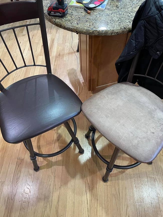 reviewer's set of two chairs, one with dark brown faux leather cover and another without