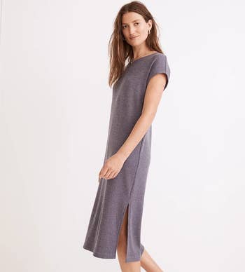 side view of model wearing the blue-gray dress to show the side slit