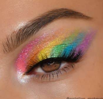 a model wearing all seven colors on their eye