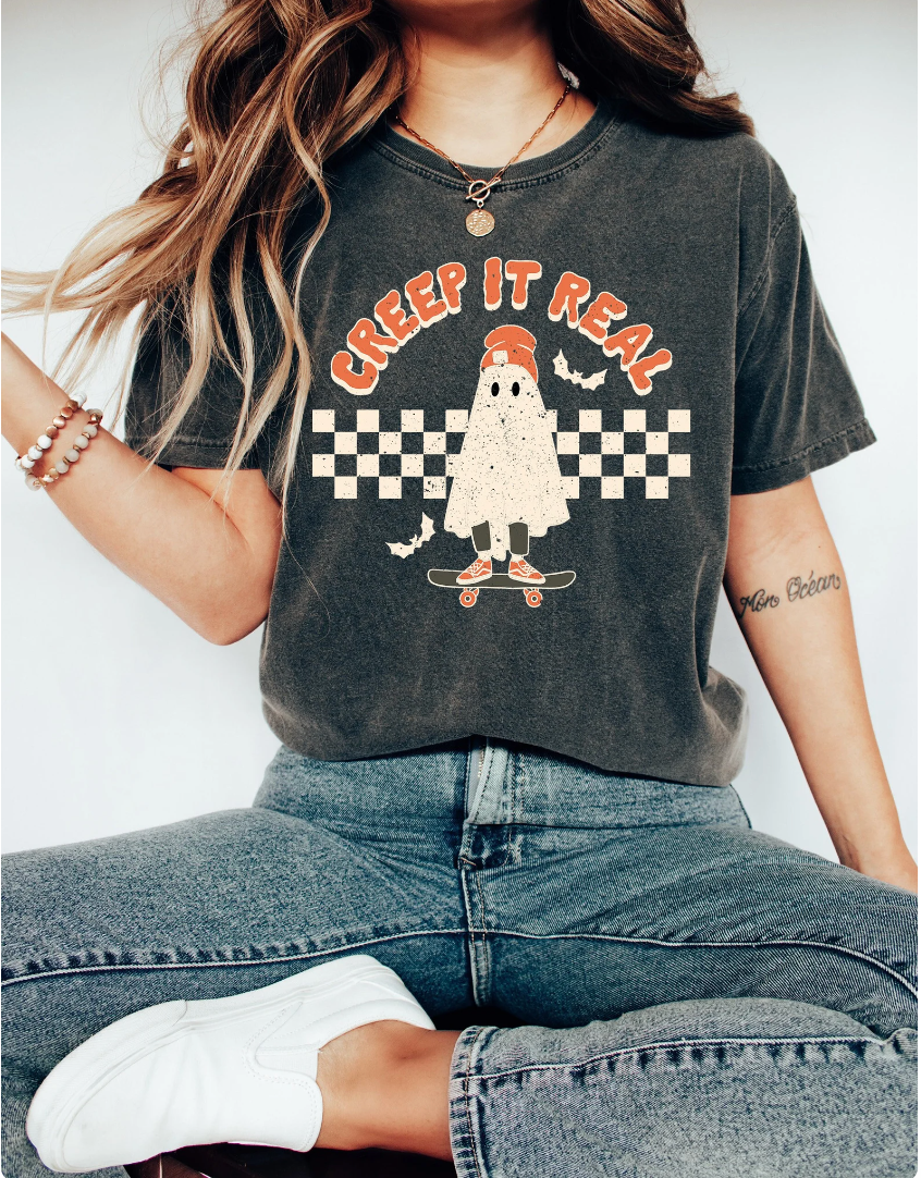 Model in a black t-shirt with a printed skateboarding host and the words