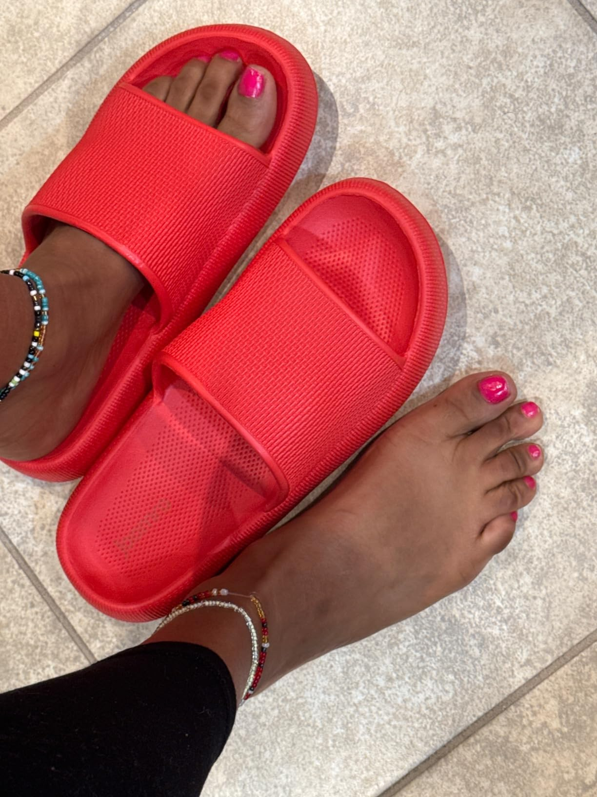 reviewer showing the reddish  sandals