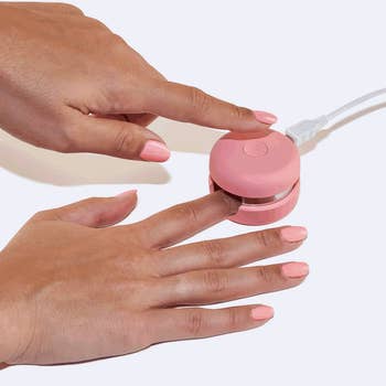 Model drying their nail in the macaron 