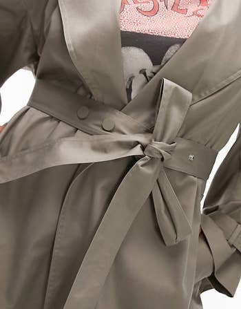 a close-up of the sash-tie belt on the trench coat 