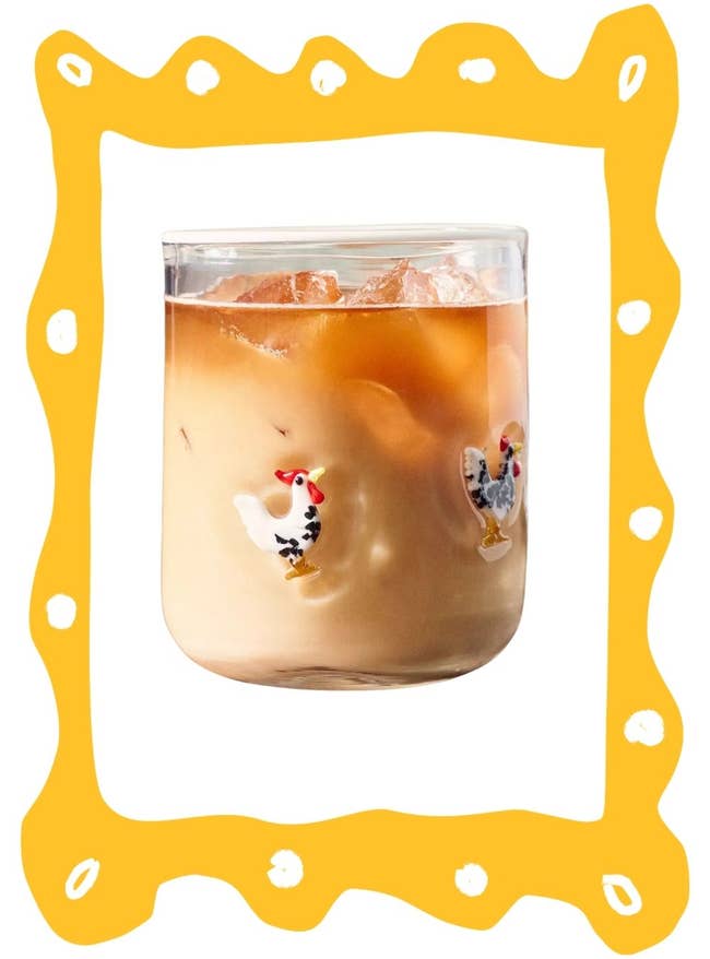 Iced coffee in a clear glass with decorative chicken motifs