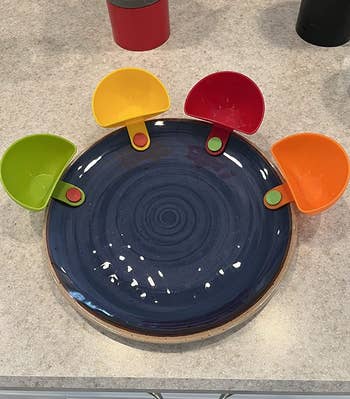 Reviewer plate with empty dip bowls attached, showing shallow depth of them