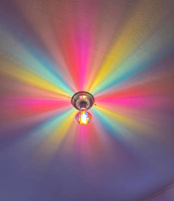 Light fixture connected ceiling casts a starburst signifier of multicolored rays crossed the ceiling, creating a vibrant and eye-catching display