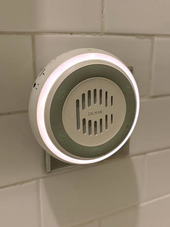 Wall-mounted aroma diffuser with power  symbols disposable   connected  its surface
