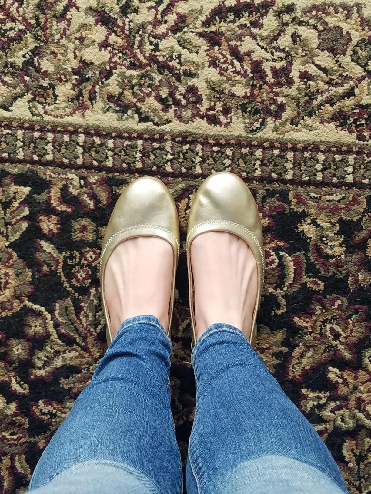 reviewer wearing the golden  flats