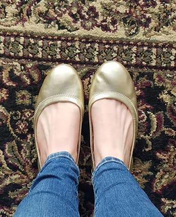 reviewer wearing the gold flats