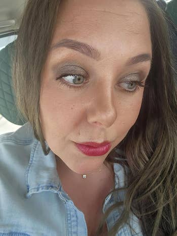 Person wearing denim overgarment   with airy  constitution  and reddish  lipstick