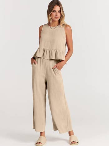 model in a sleeveless off white peplum top and wide-leg pants