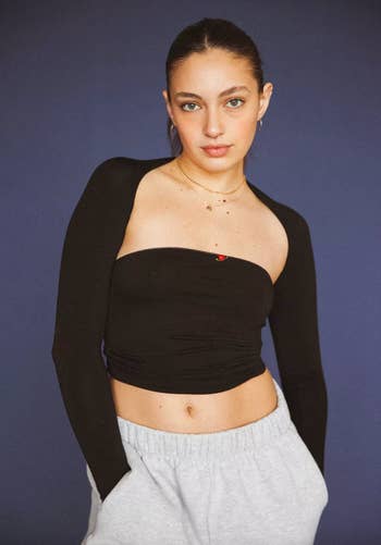 Model wearing the tube top in black with a black bolero