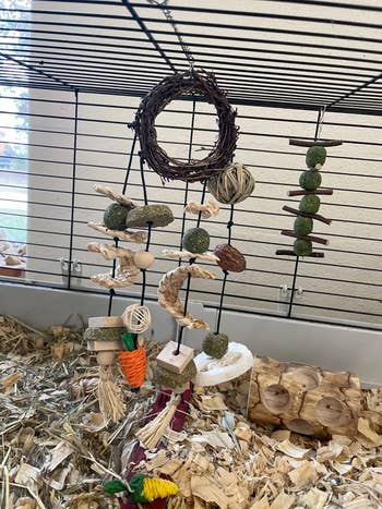 another reviewer's toy hanging from the cage showing all different aspects of it