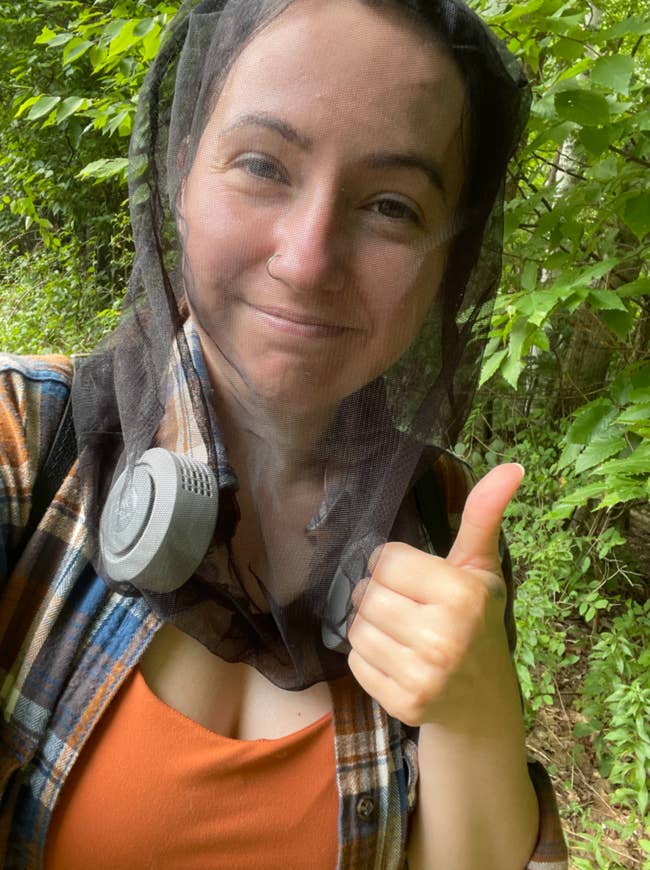 Writer is wearing the black net around her head during a hike