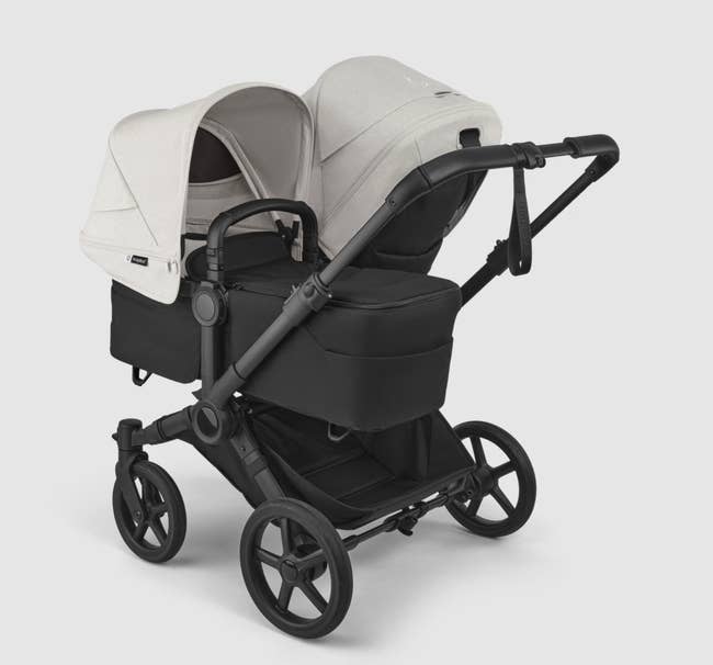 Double stroller with adjustable canopies and retention space, showcasing features for caring for 2 children efficiently