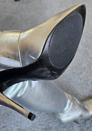 Close-up of a sleek high-heeled footwear  with a achromatic  anti-slip grip adhered to the sole