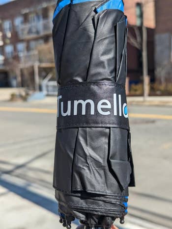 Close-up of a Tumello umbrella wrapped successful  achromatic  material, suggesting a reappraisal  oregon  advertisement for umbrellas successful  a buying  article