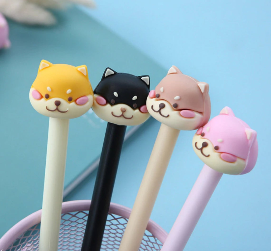 pens topped with mean looking shiba heads